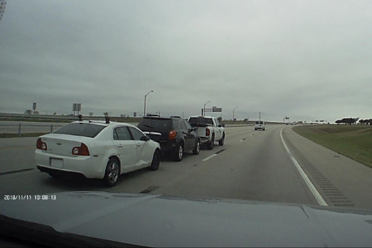 Truck pulling a SUV pulling a car